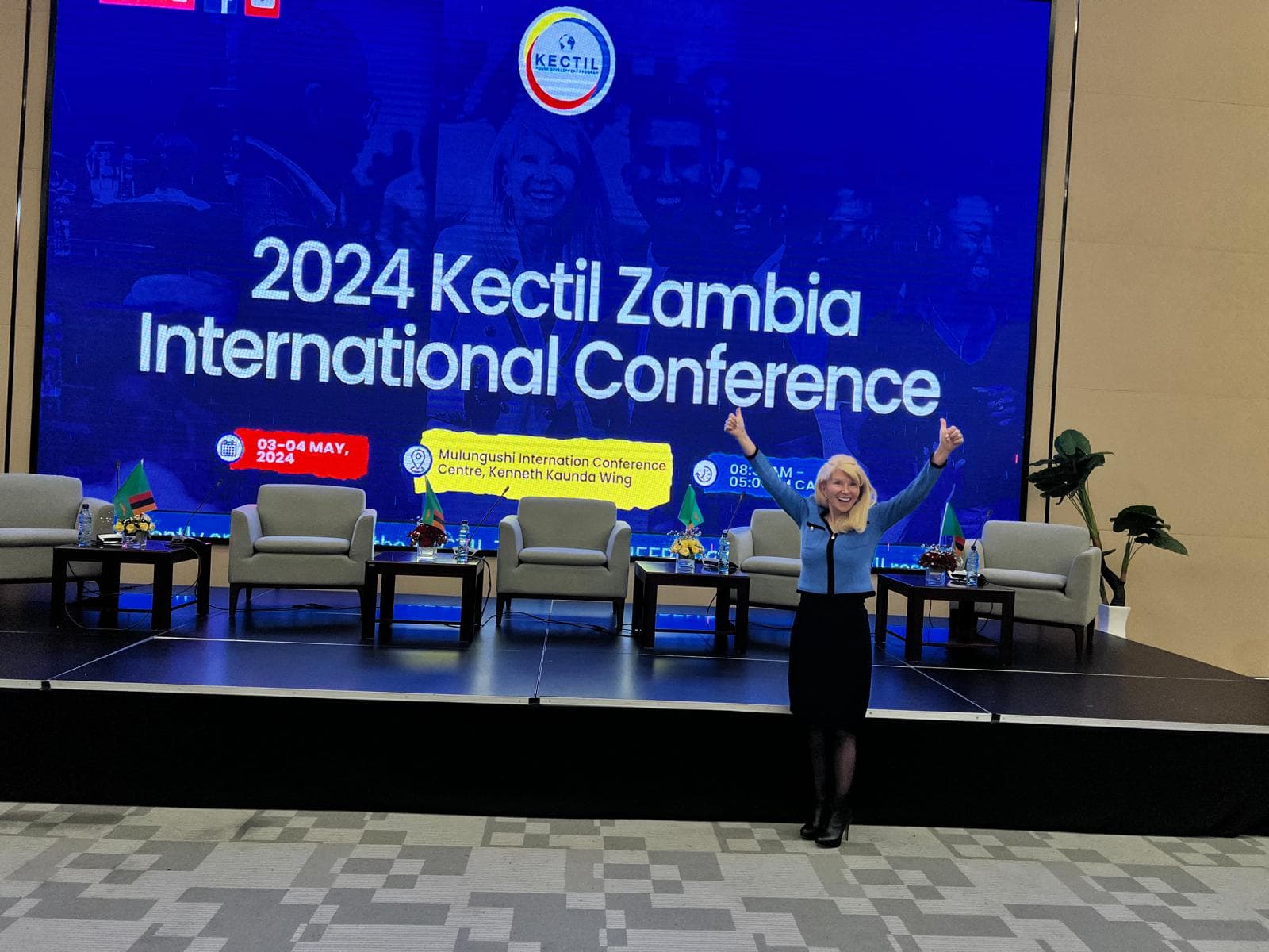 Kectil participants standing on a conference stage in Zambia.